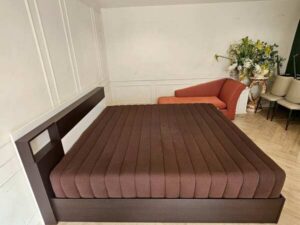 Asian-Bed brand pocket spring mattress with soft, feather-like fabric cover, dark brown color.