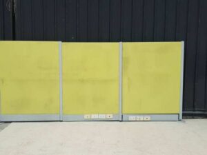Office partition with power outlet, light green.