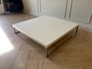 Coffee table with white synthetic stone top and stainless steel legs. (1)