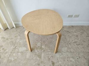 Set of two stacking wooden tables, triangular shape, curved legs, IKEA brand.