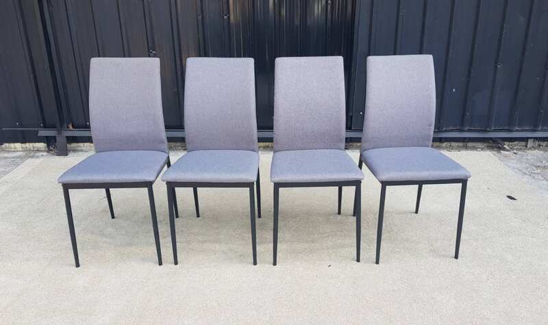 Chair with metal legs and light gray fabric seat.