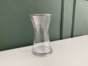 Tall, clear glass flower vase.