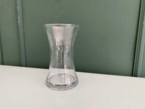 Tall, clear glass flower vase.