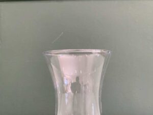 Tall, clear glass flower vase.