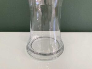Tall, clear glass flower vase.