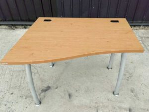 L-shaped desk with curved steel legs.
