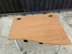 L-shaped desk with curved steel legs.