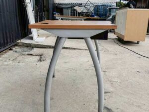 L-shaped desk with curved steel legs.