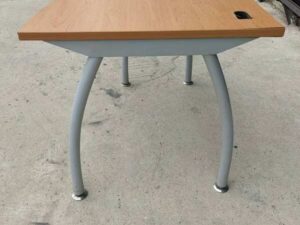 L-shaped desk with curved steel legs.