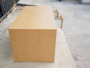 Two-drawer desk, brown wooden frame, 150 cm wide.