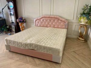 6-foot bed with leather cushions and button-tufted pink mattress. 6-foot mattress, 9-inch thick.