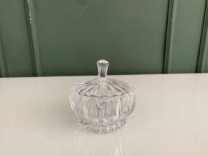 Multipurpose glass jar with grooved pattern and lid, vintage style.