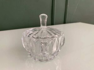 Multipurpose glass jar with grooved pattern and lid, vintage style.