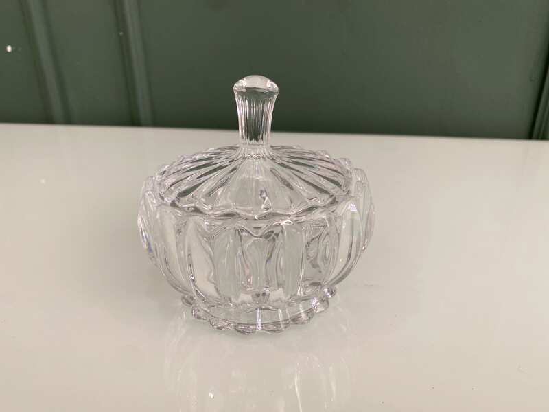 Multipurpose glass jar with grooved pattern and lid, vintage style.