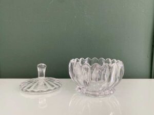 Multipurpose glass jar with grooved pattern and lid, vintage style.