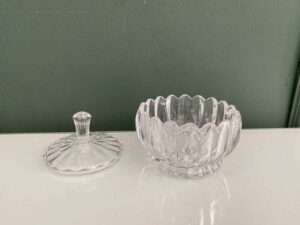 Multipurpose glass jar with grooved pattern and lid, vintage style.