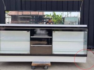 Black display cabinet with two glass doors and five wooden doors.