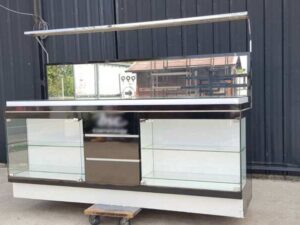 Black display cabinet with two glass doors and five wooden doors.
