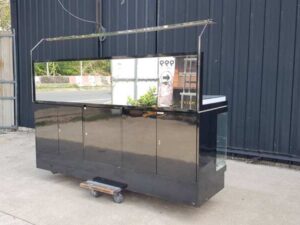 Black display cabinet with two glass doors and five wooden doors.