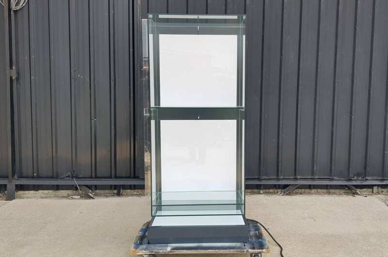 Two-shelf glass display case, black.