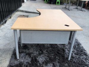 L-shaped work desk, gray steel frame, wooden top.