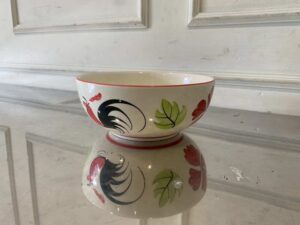 8-inch ceramic bowl with rooster logo, red rim.