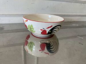 8-inch ceramic bowl with rooster logo, red rim.