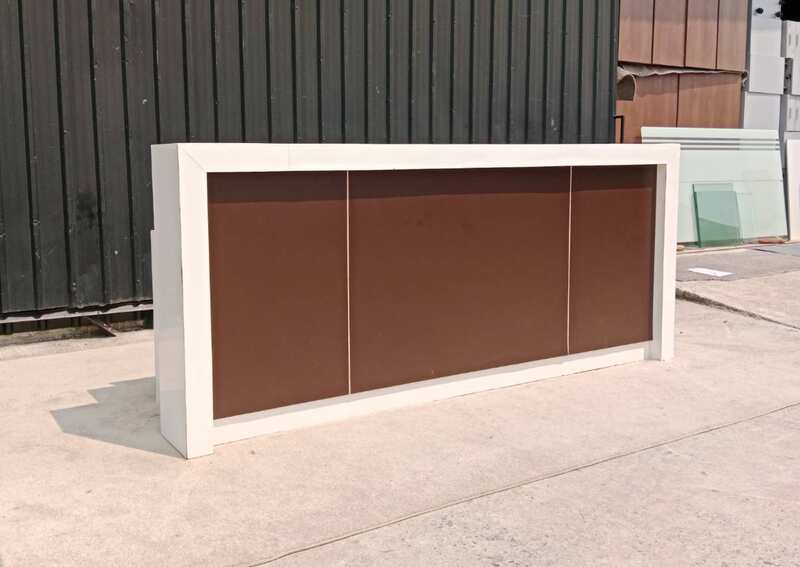 White and brown wooden counter with 3 drawers.