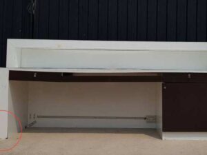 White and brown wooden counter with 3 drawers.