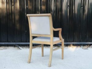 Teak frame chair with arms and light gray leather cushion._L5ATRUCEIH_WVRJK0668G