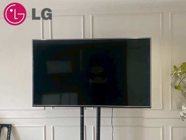 65-inch wall-mounted TV, LG brand, model 65UH615T