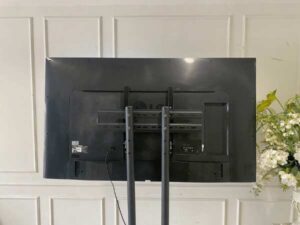 65-inch wall-mounted TV, LG brand, model 65UH615T