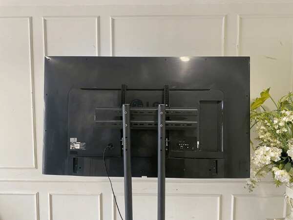 65-inch wall-mounted TV, LG brand, model 65UH615T