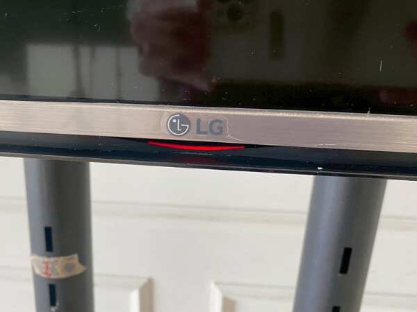 65-inch wall-mounted TV, LG brand, model 65UH615T