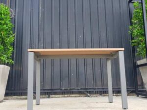 Work desk with brown wood top and gray steel legs.