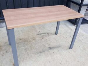 Work desk with brown wood top and gray steel legs.