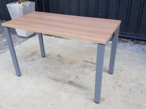 Work desk with brown wood top and gray steel legs.