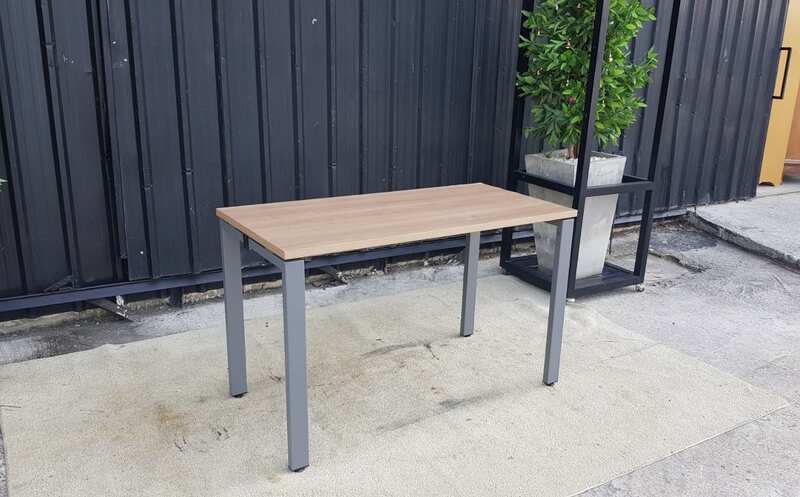 Work desk with brown wood top and gray steel legs.