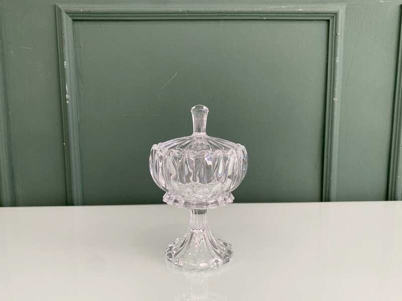 Crystal glass bowl with grooved lid and base.