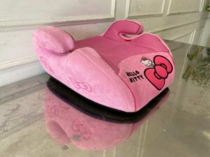 Child car booster seat with Kitty embroidery, pink color.