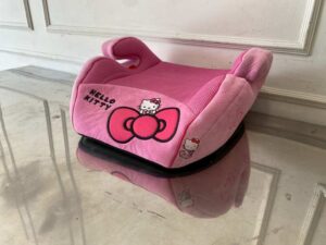 Child car booster seat with Kitty embroidery, pink color.