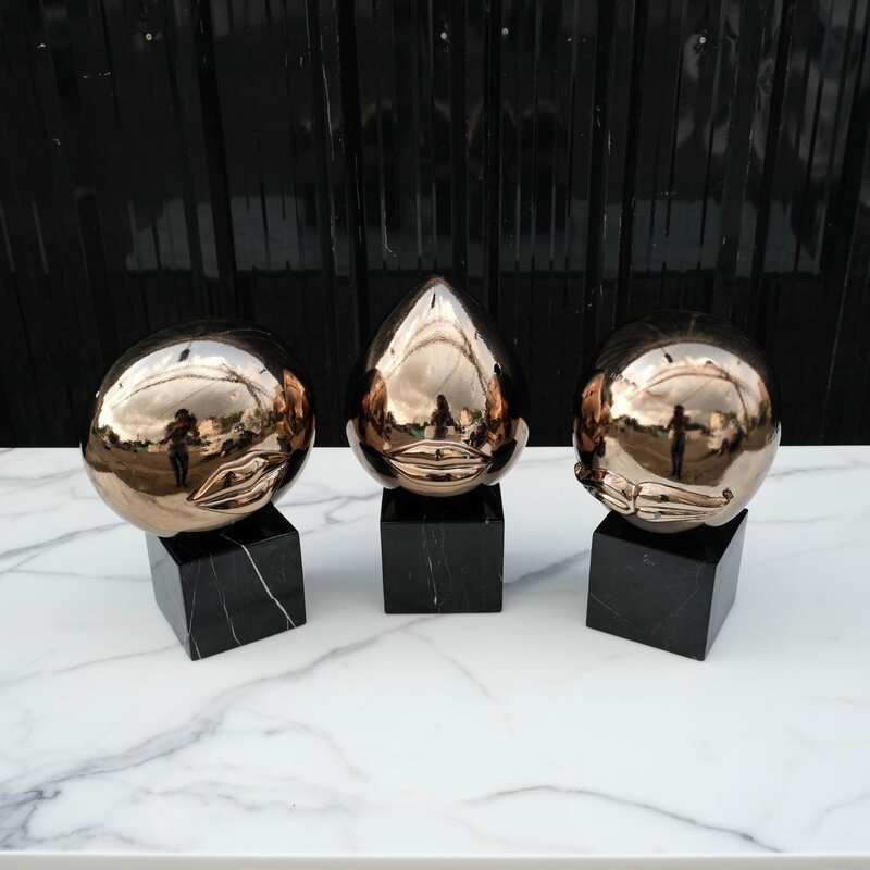 Water decoration, golden shape, black marble base.
