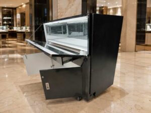 Black glass display cabinet featuring 2 doors, 2 drawers, and 1 storage compartment.