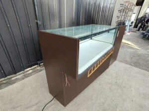 Brown glass display cabinet featuring 2 hinged-door compartments, 2 drawers, and 1 storage compartment (no keys; all sections are accessible).