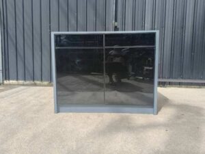 Display cabinet with glass panels on the top and all four sides (front and back).