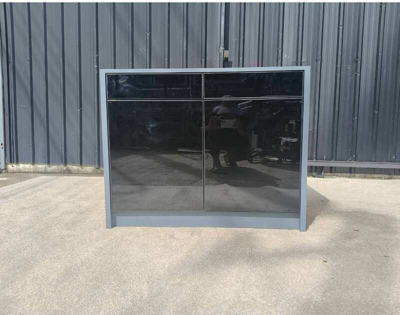 Display cabinet with glass panels on the top and all four sides (front and back).