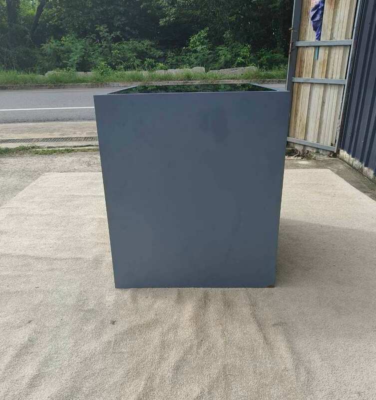 Display cabinet with glass panels on the top and all four sides (front and back).