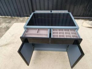 Display cabinet with glass panels on the top and all four sides (front and back).