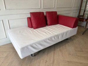 White daybed sofa with red trim, modern style.
