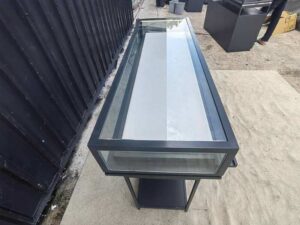Glass display case, jewelry case, with iron legs and lights.